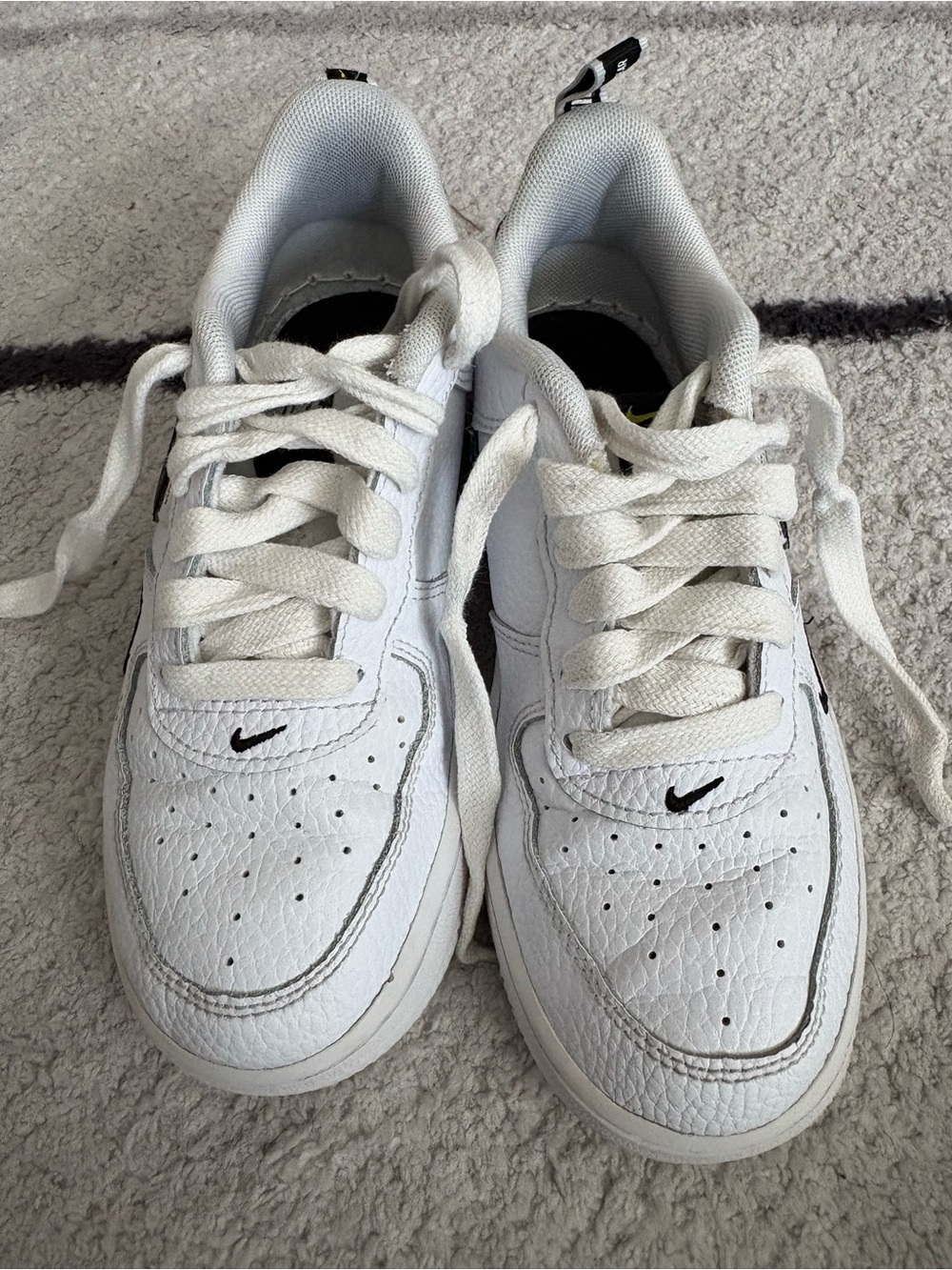Nike Kids White Low-Top Sneakers with Black Swoosh